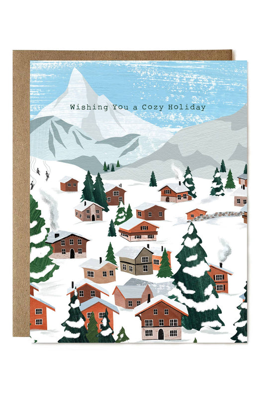 Holiday card with a snowy mountain village scene and 'Wishing You a Cozy Holiday' text.