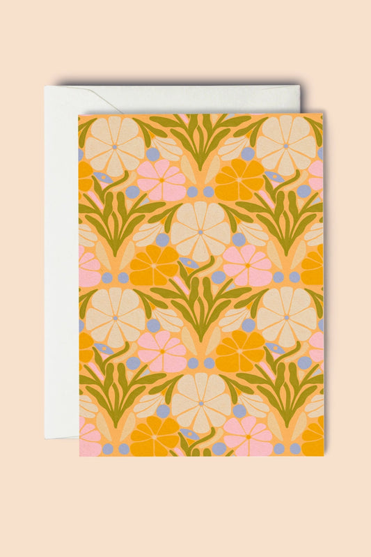Floral patterned card with a white envelope on a beige background