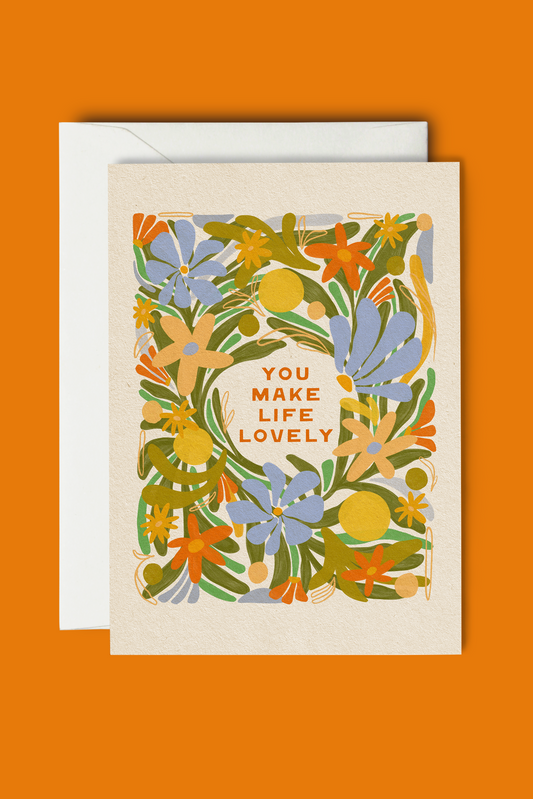 Greeting card with floral design and 'You Make Life Lovely' text on an orange background