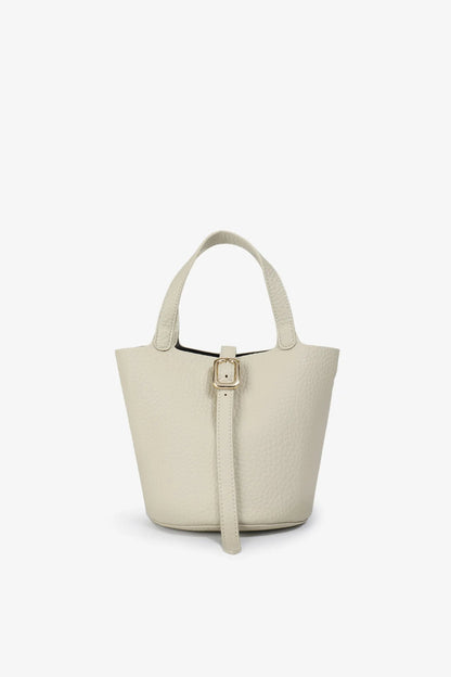 Beige handbag with a strap on a white background