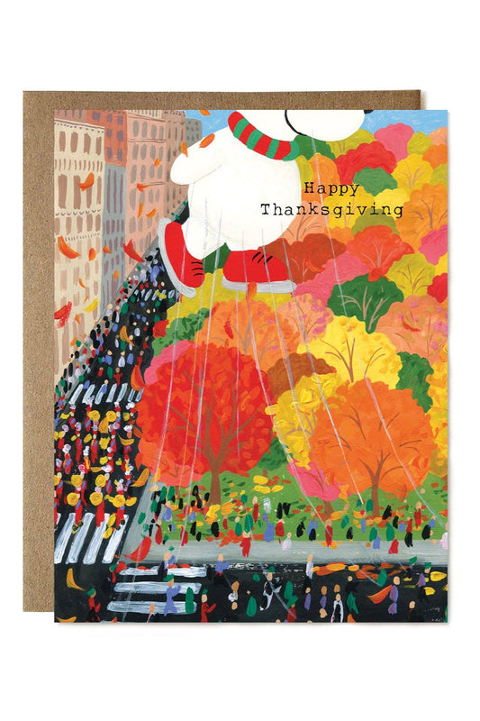 Colorful Thanksgiving card with a busy street scene and 'Happy Thanksgiving' text.